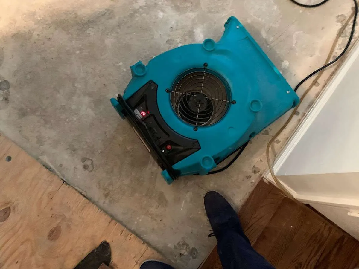 Air mover drying subfloor during Commercial Water Damage Restoration in Evergreen Park